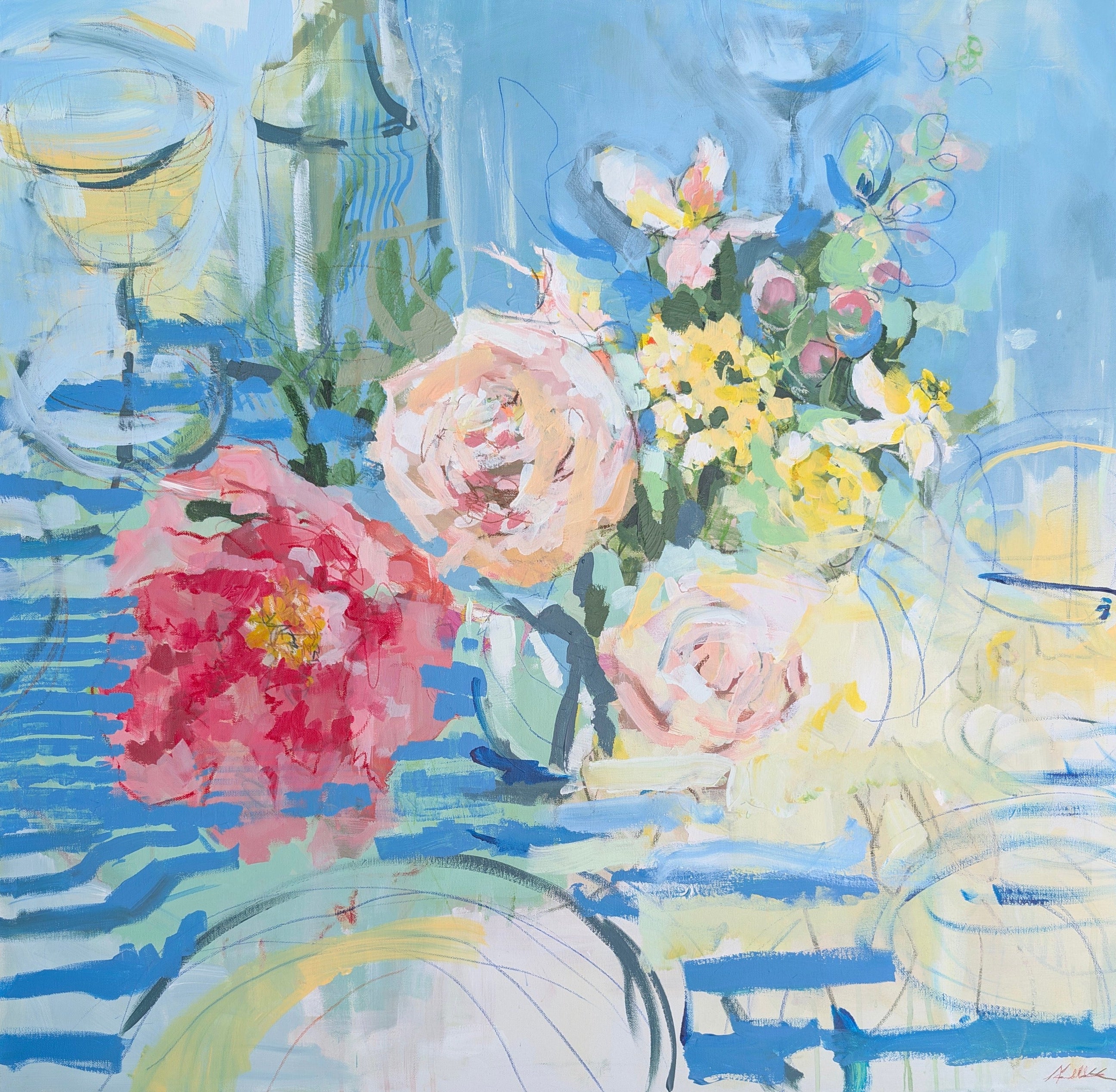 Colorful floral arrangement with wine glasses on a blue background