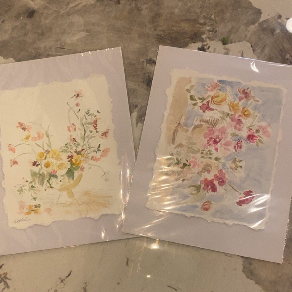 Two floral greeting cards on a textured surface